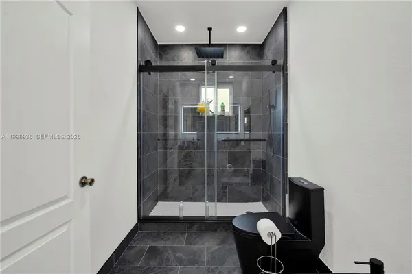 a bathroom with a shower and toilet