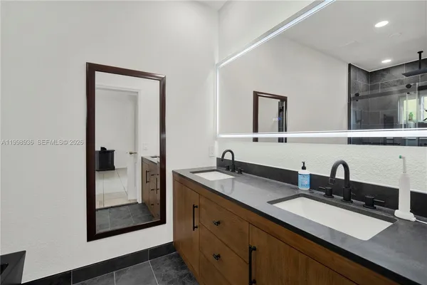 a bathroom with a sink and two mirror