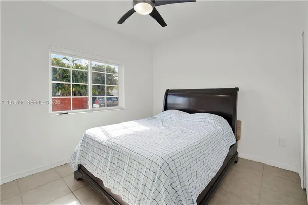 a bedroom with a bed and window