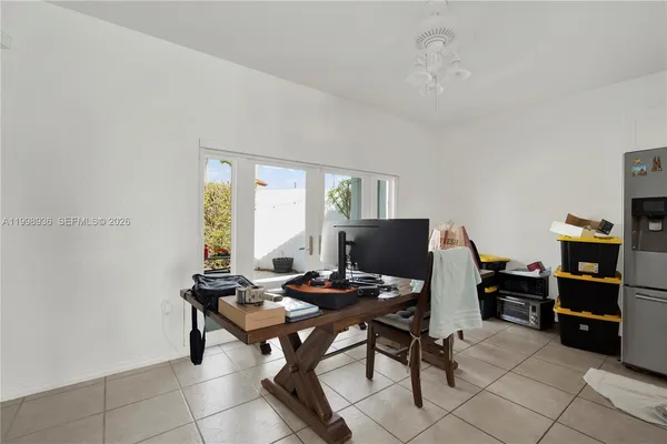 a view of a workspace with furniture and a window
