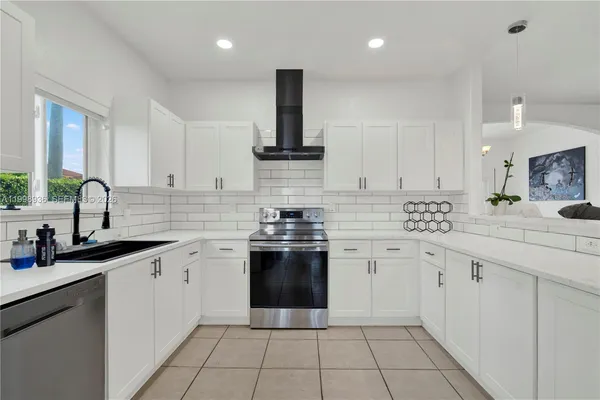 a kitchen with a sink stove and cabinets