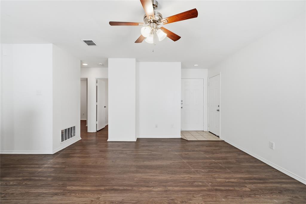 4005 Freedom Street Forney, TX 75126 - Photo 11 of 40 an empty room with wooden floor fan and windows