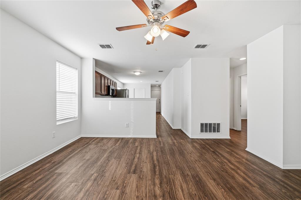 4005 Freedom Street Forney, TX 75126 - Photo 12 of 40 a view of a room with wooden floors and a ceiling fan