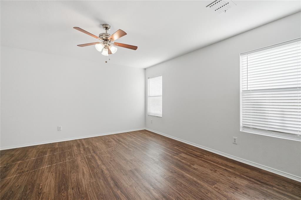 4005 Freedom Street Forney, TX 75126 - Photo 18 of 40 an empty room with wooden floor window and a ceiling fan