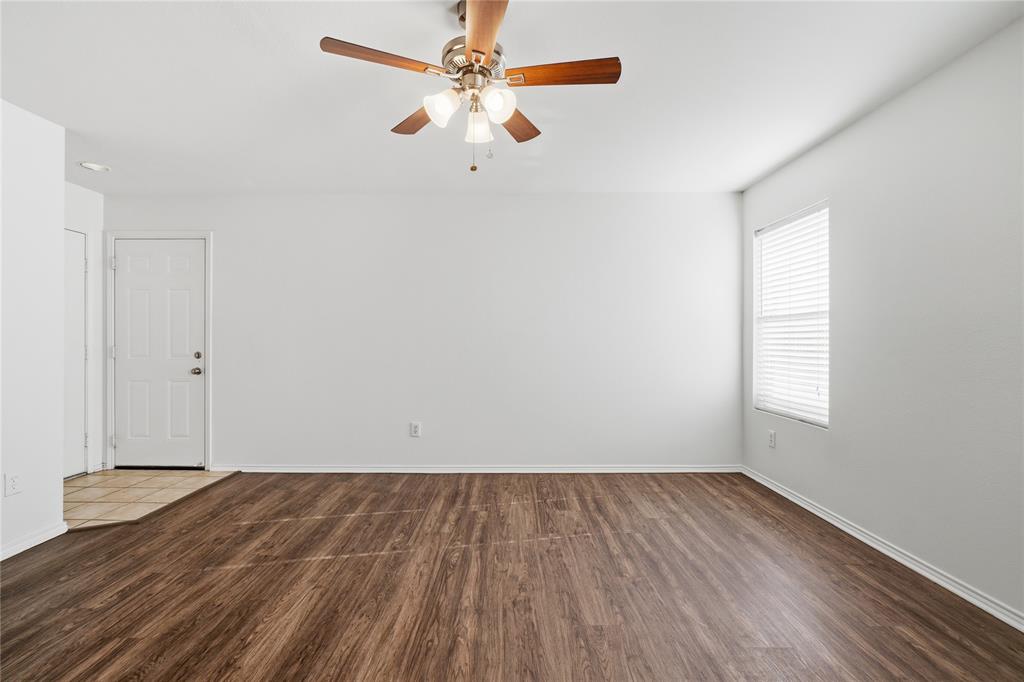 4005 Freedom Street Forney, TX 75126 - Photo 19 of 40 an empty room with wooden floor fan and windows