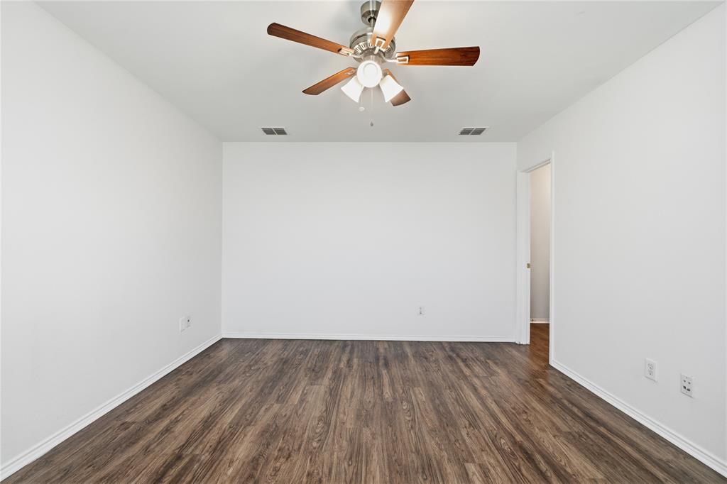 4005 Freedom Street Forney, TX 75126 - Photo 22 of 40 an empty room with wooden floor and a ceiling fan