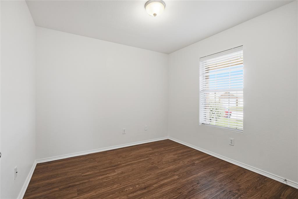 4005 Freedom Street Forney, TX 75126 - Photo 25 of 40 an empty room with wooden floor and windows