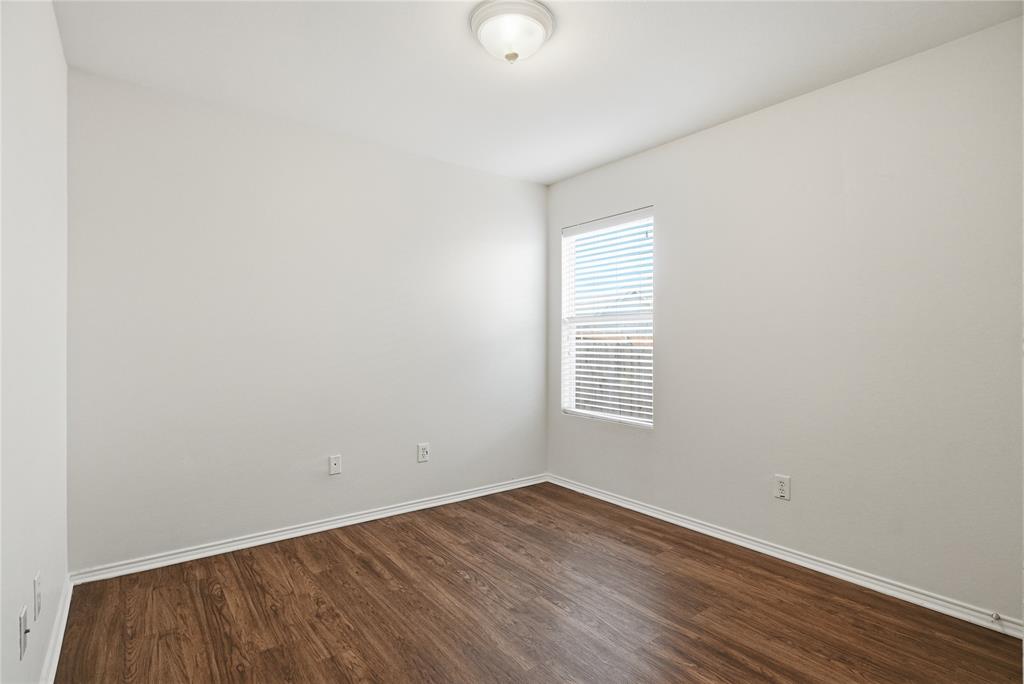 4005 Freedom Street Forney, TX 75126 - Photo 29 of 40 an empty room with wooden floor and windows