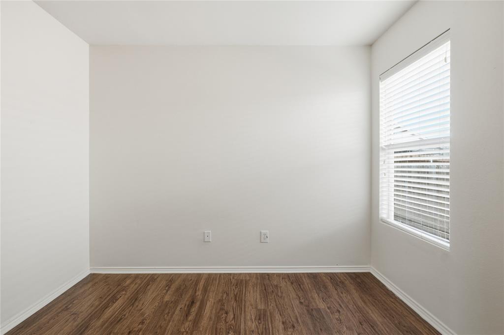 4005 Freedom Street Forney, TX 75126 - Photo 32 of 40 an empty room with wooden floor and windows