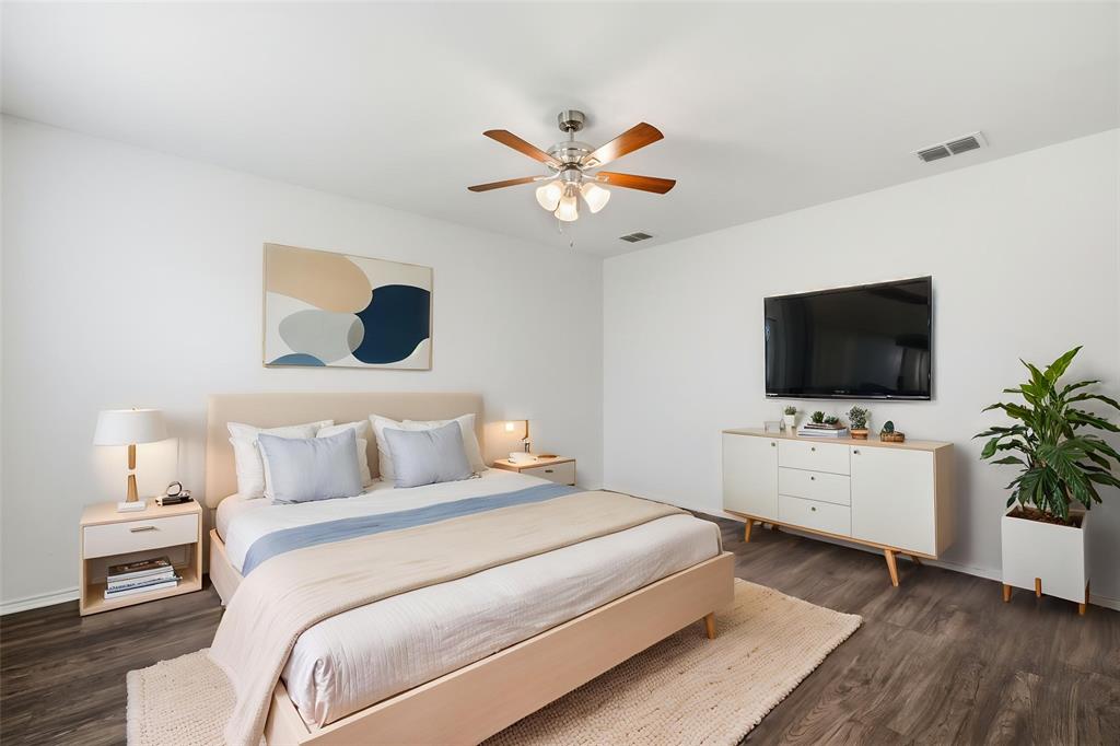 4005 Freedom Street Forney, TX 75126 - Photo 8 of 40 a bedroom with a bed and a flat screen tv