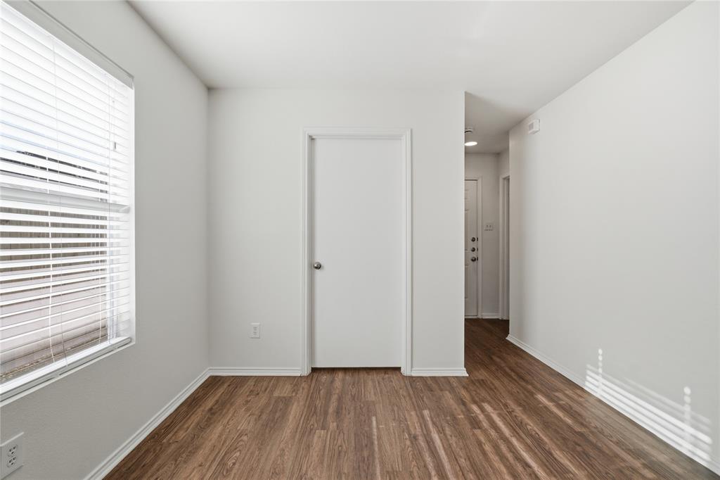 4005 Freedom Street Forney, TX 75126 - Photo 9 of 40 a view of an empty room with wooden floor and a window