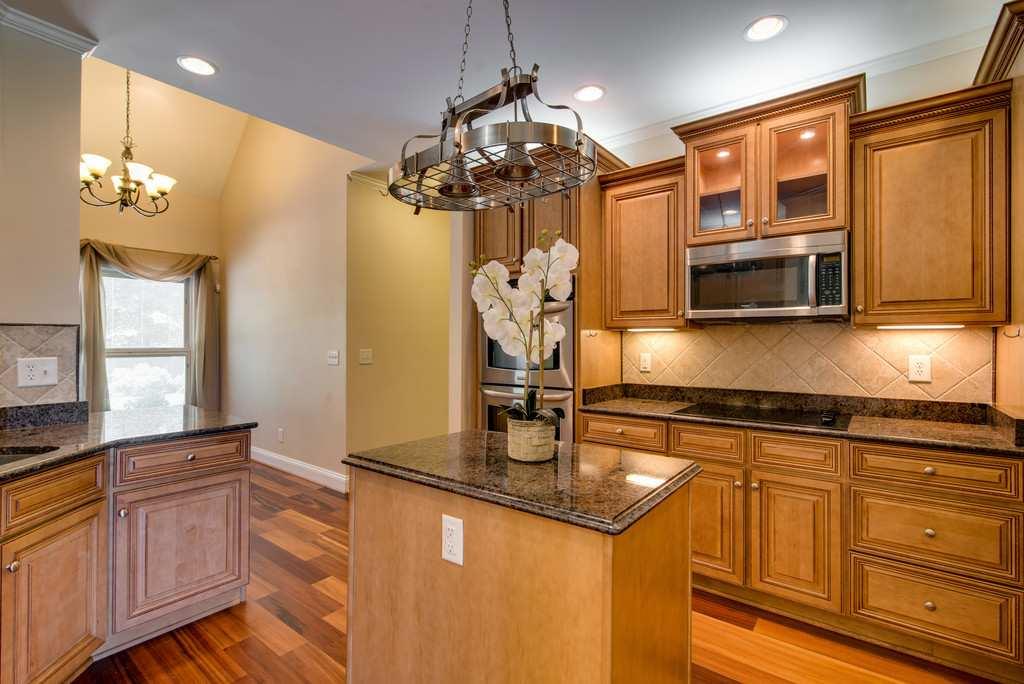 4845 Starks Road Cross Plains, TN 37049 - Photo 11 of 30 a kitchen with stainless steel appliances granite countertop a sink dishwasher and a microwave oven with granite countertops
