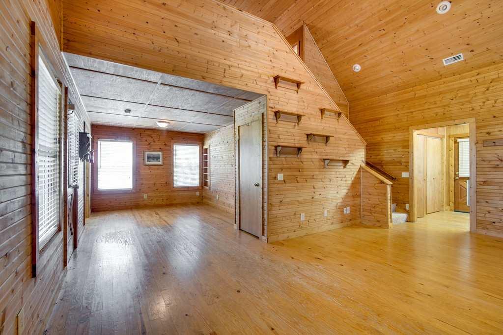 4845 Starks Road Cross Plains, TN 37049 - Photo 21 of 30 a view of a livingroom with wooden floor and a ceiling fan