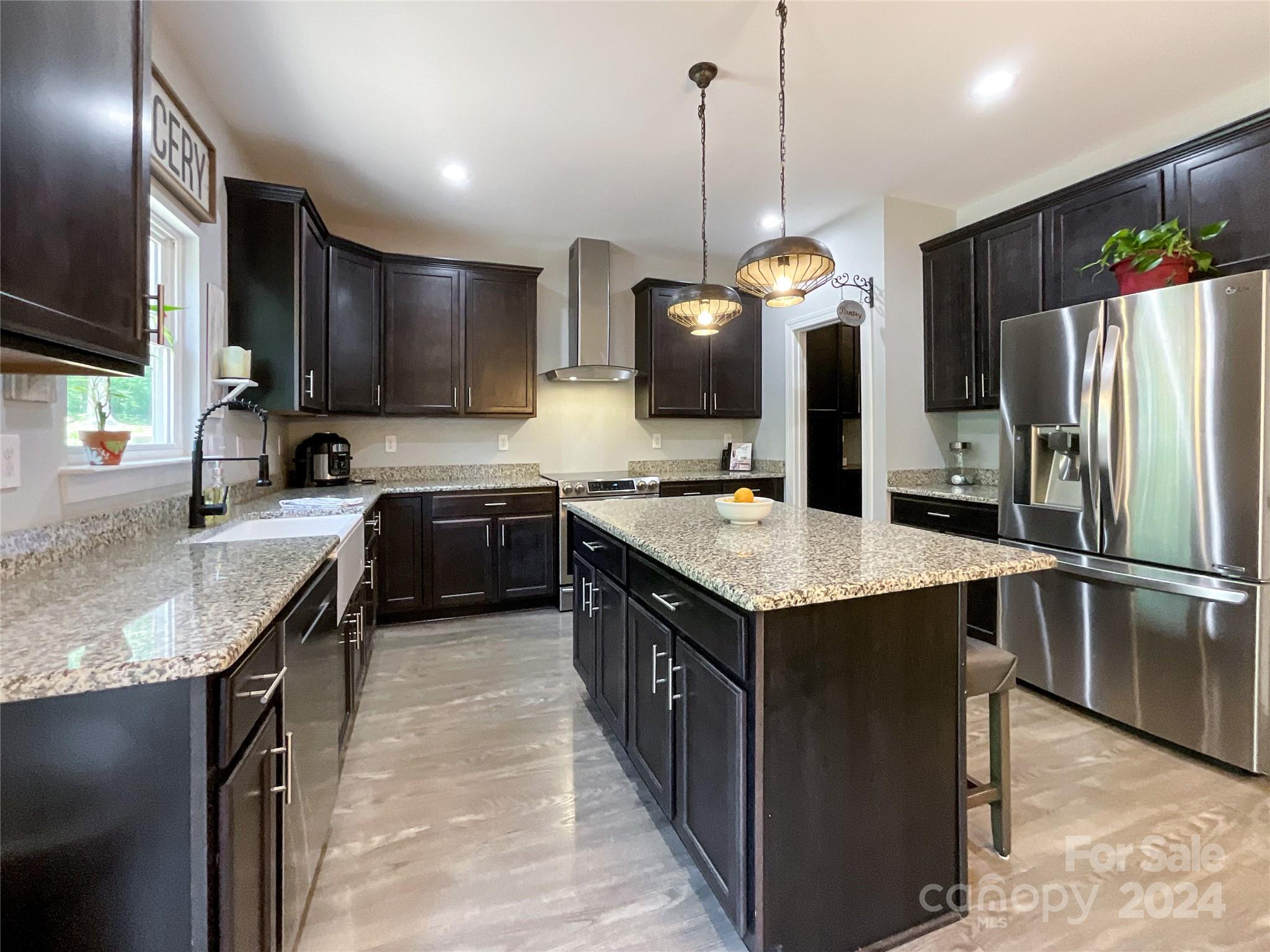9408 Deer Run Road Waxhaw, NC 28173 - Photo 13 of 47 a kitchen with stainless steel appliances granite countertop a sink a stove and a refrigerator