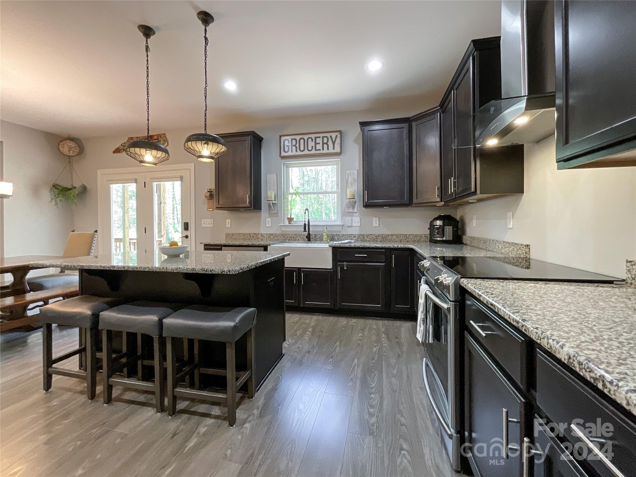 9408 Deer Run Road Waxhaw, NC 28173 - Photo 14 of 47 a kitchen with a kitchen island wooden floor and stainless steel appliances