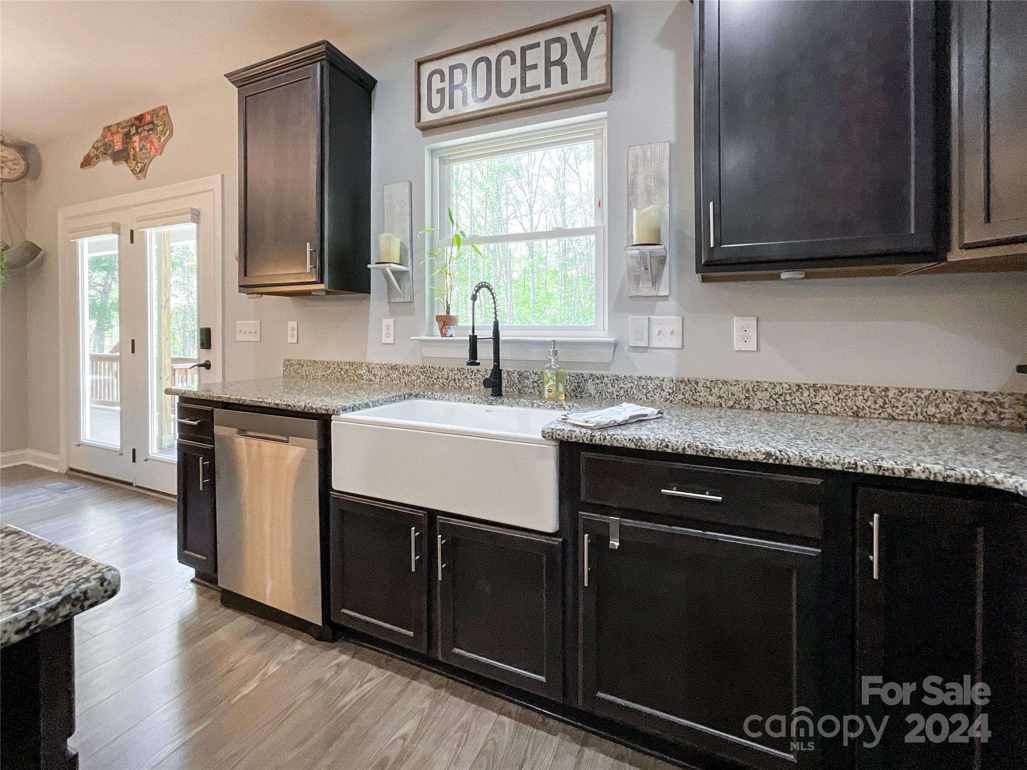 9408 Deer Run Road Waxhaw, NC 28173 - Photo 15 of 47 a kitchen with stainless steel appliances granite countertop a sink stove and cabinets