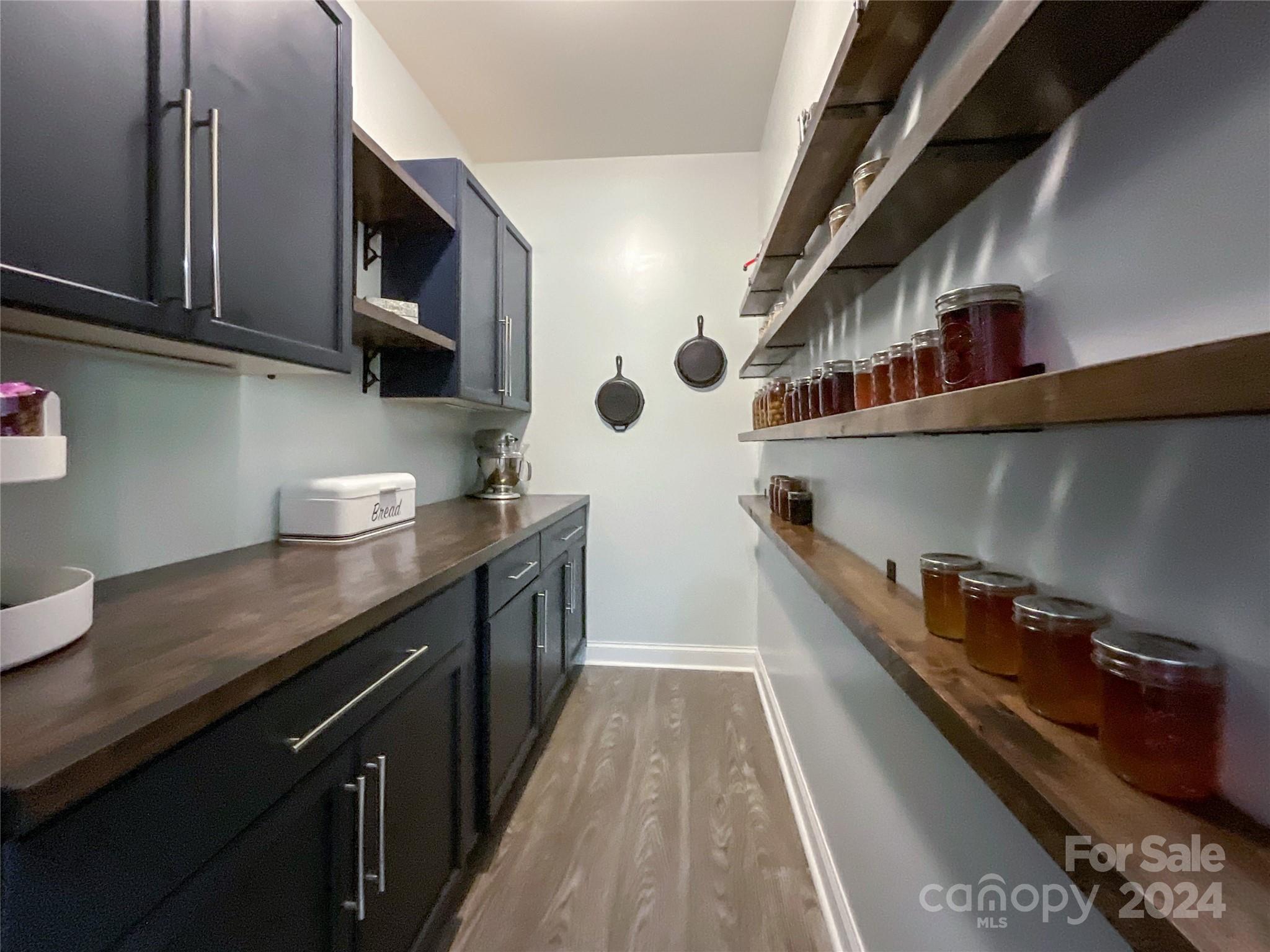 9408 Deer Run Road Waxhaw, NC 28173 - Photo 16 of 47 a kitchen with stainless steel appliances granite countertop a sink a stove and a wooden floors