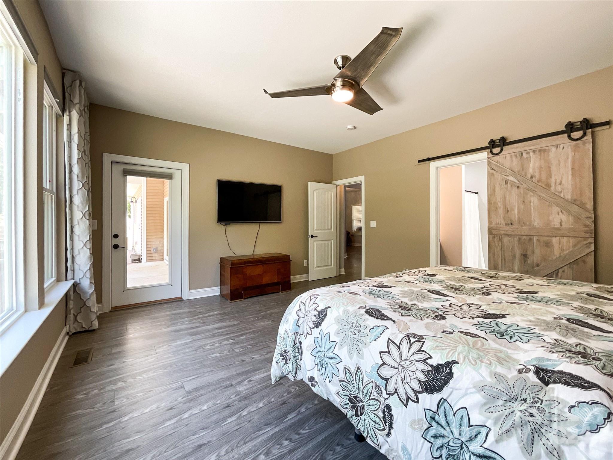 9408 Deer Run Road Waxhaw, NC 28173 - Photo 19 of 47 a spacious bedroom with a bed and a flat screen tv