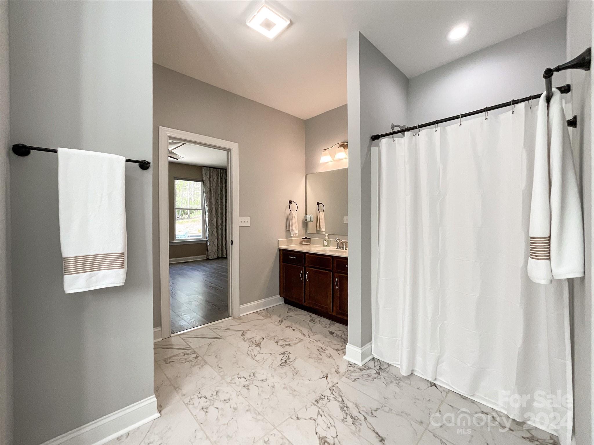 9408 Deer Run Road Waxhaw, NC 28173 - Photo 21 of 47 a bathroom with a bathtub and a shower