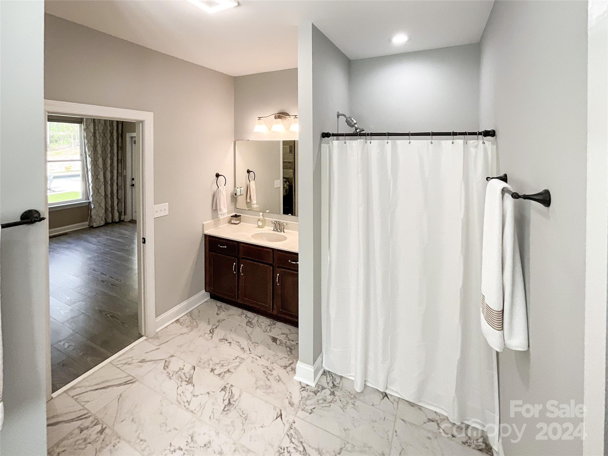 9408 Deer Run Road Waxhaw, NC 28173 - Photo 24 of 47 a bathroom with a tub sink and a mirror