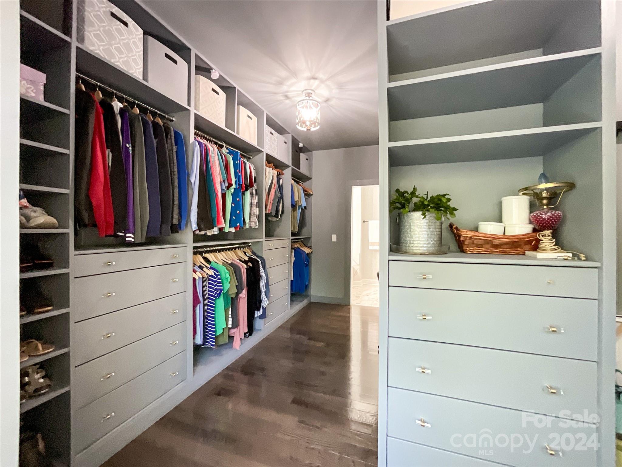 9408 Deer Run Road Waxhaw, NC 28173 - Photo 26 of 47 a view of walk in closet with clothes and shoes