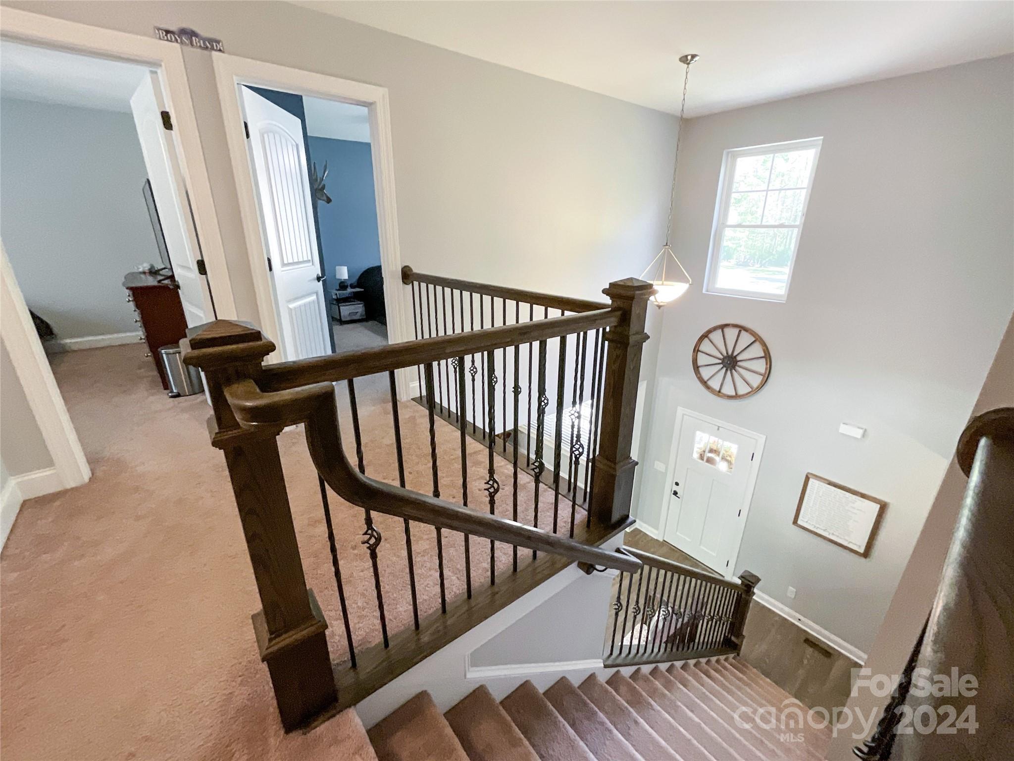 9408 Deer Run Road Waxhaw, NC 28173 - Photo 28 of 47 a view of a hallway with wooden floor and stairs