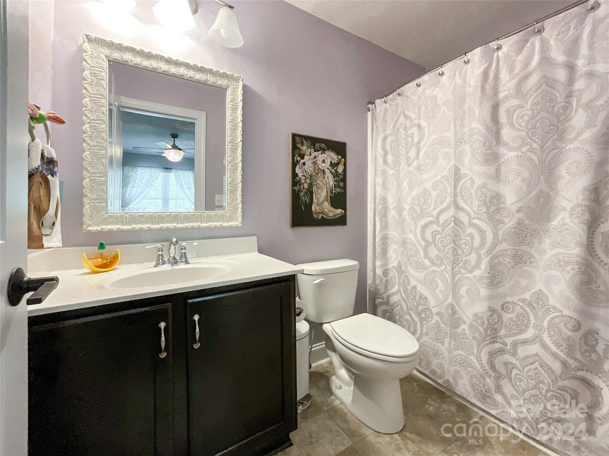 9408 Deer Run Road Waxhaw, NC 28173 - Photo 30 of 47 a bathroom with a toilet sink and mirror