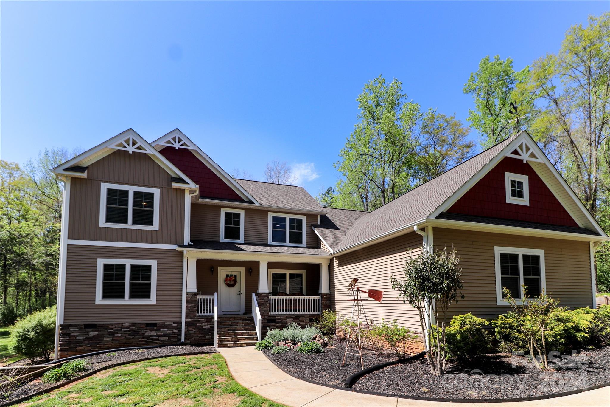 9408 Deer Run Road Waxhaw, NC 28173 - Photo 3 of 47 a front view of a house with garden
