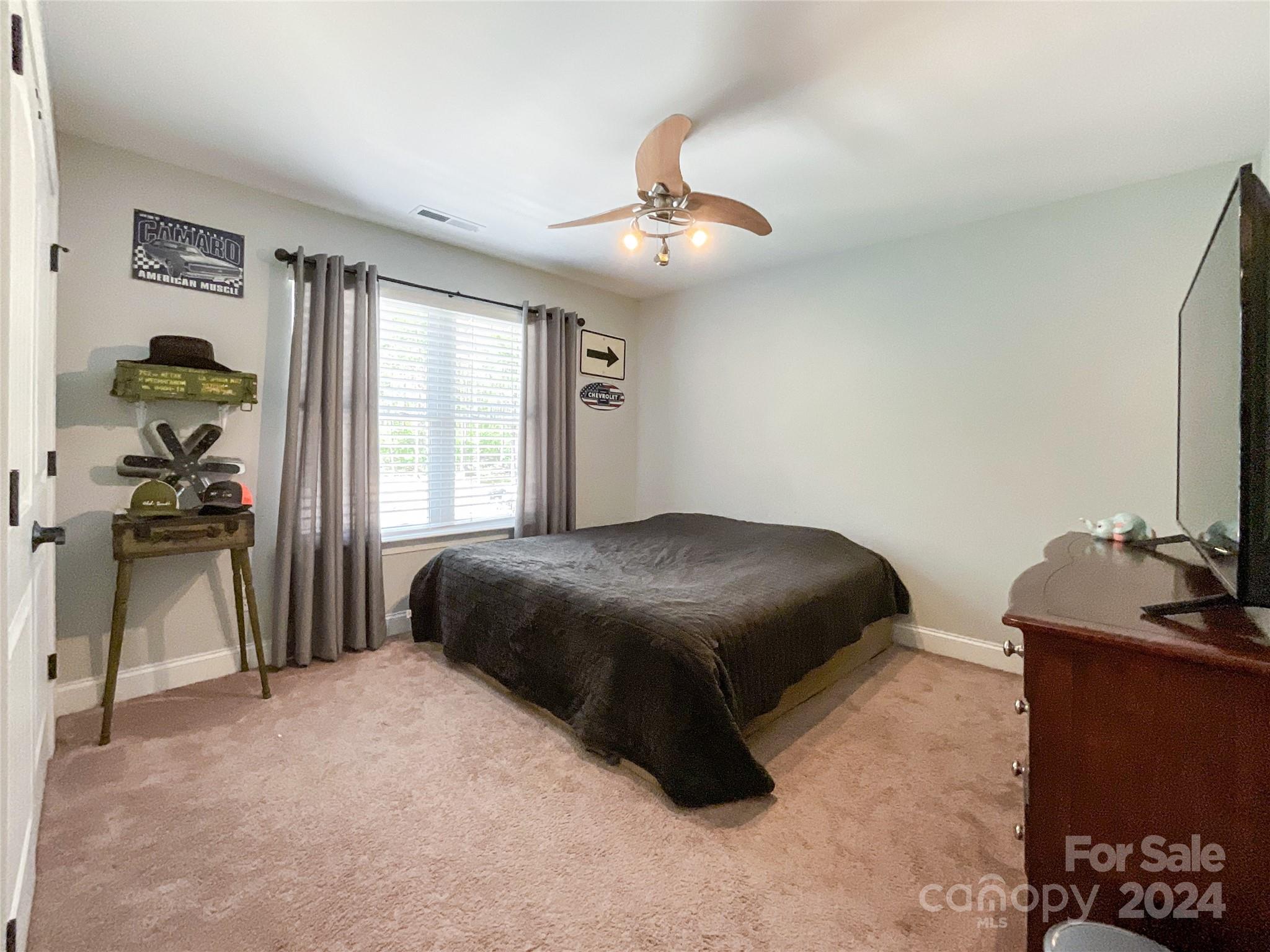 9408 Deer Run Road Waxhaw, NC 28173 - Photo 33 of 47 a bedroom with a bed and a chair