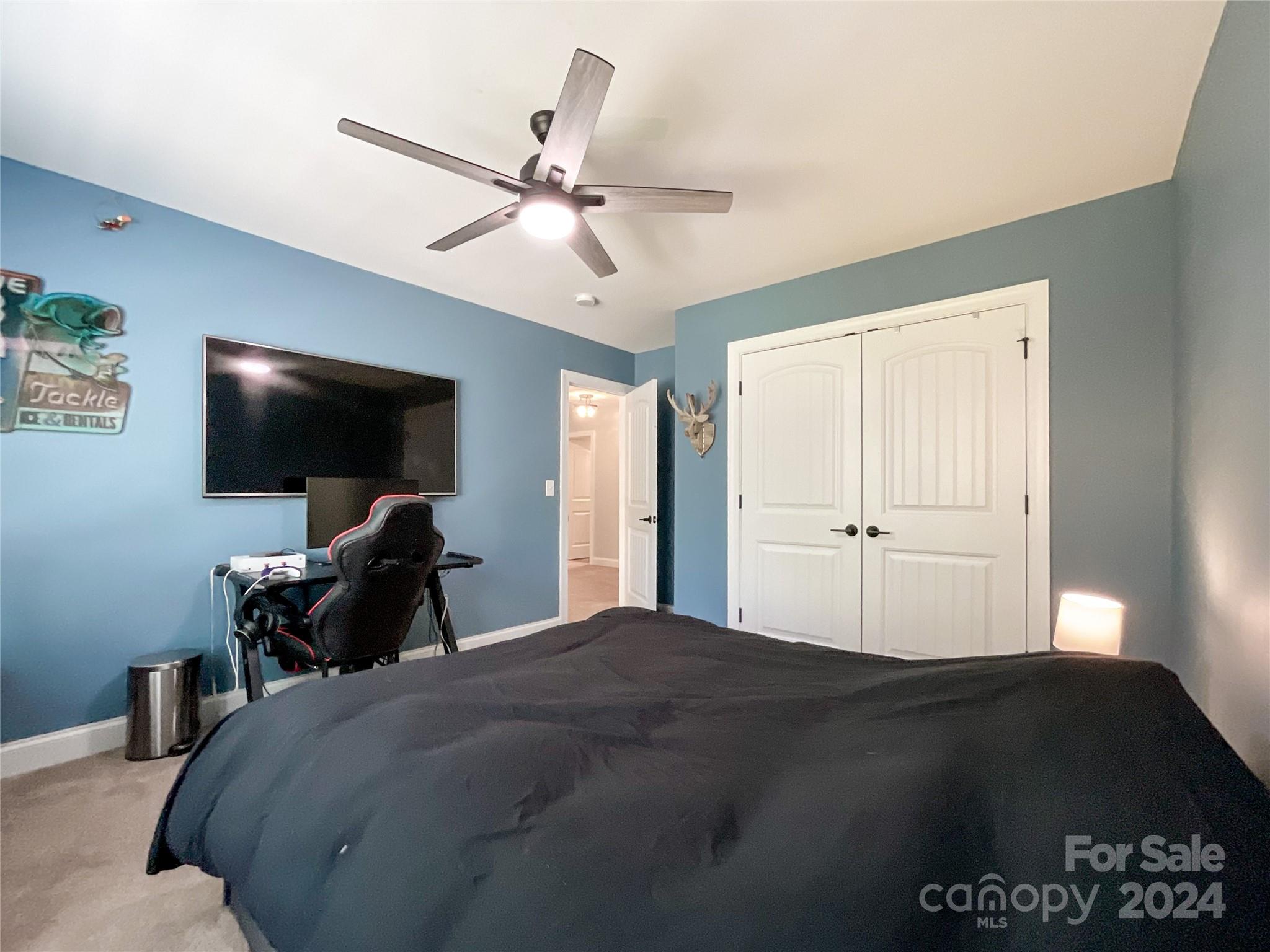 9408 Deer Run Road Waxhaw, NC 28173 - Photo 35 of 47 a bedroom with a bed and a flat screen tv