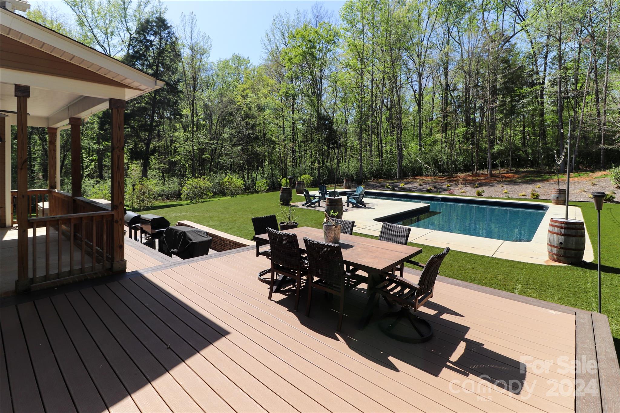 9408 Deer Run Road Waxhaw, NC 28173 - Photo 47 of 47 a view of a swimming pool with chairs and table on the wooden floor