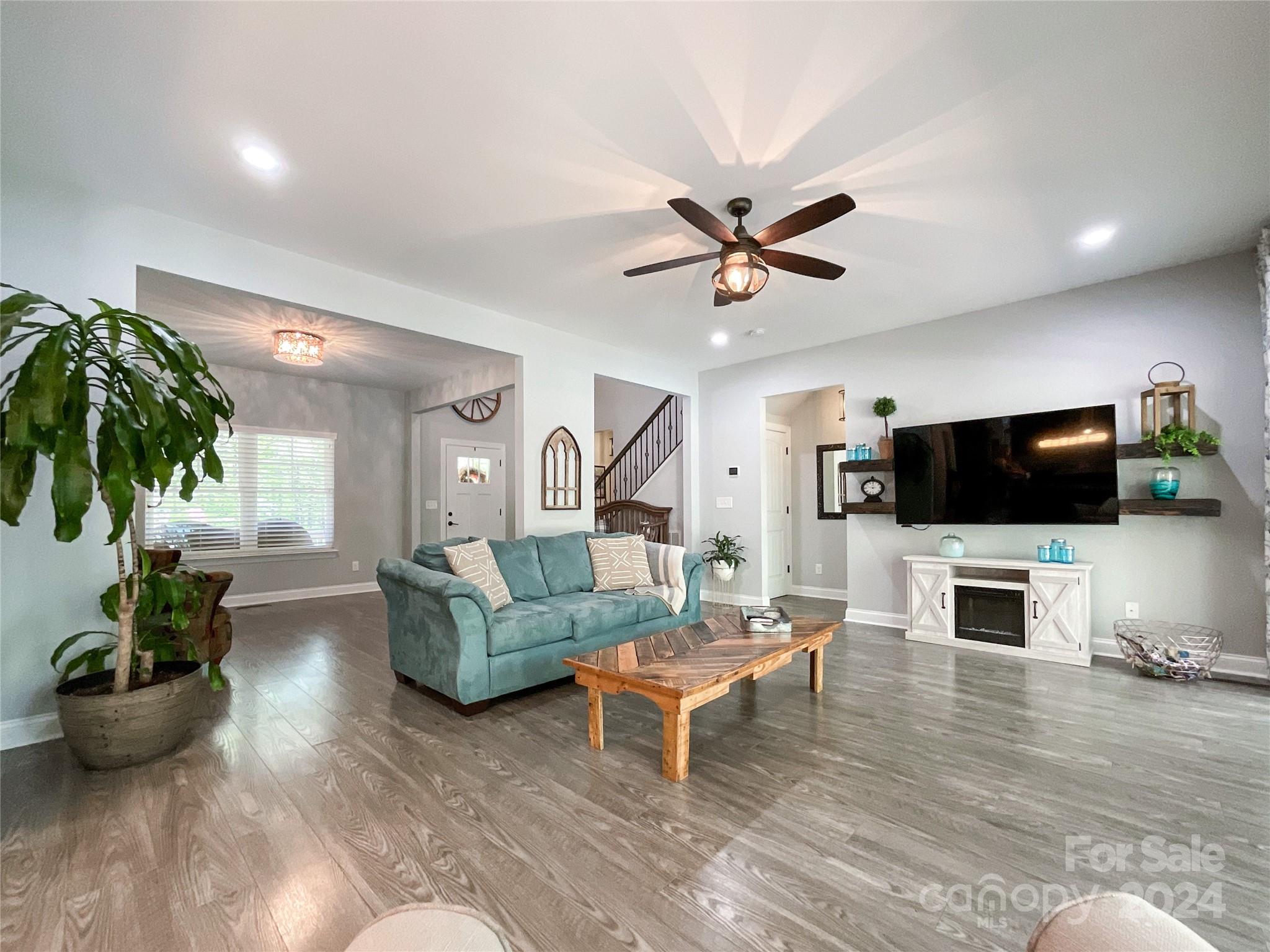 9408 Deer Run Road Waxhaw, NC 28173 - Photo 9 of 47 a living room with furniture and a flat screen tv
