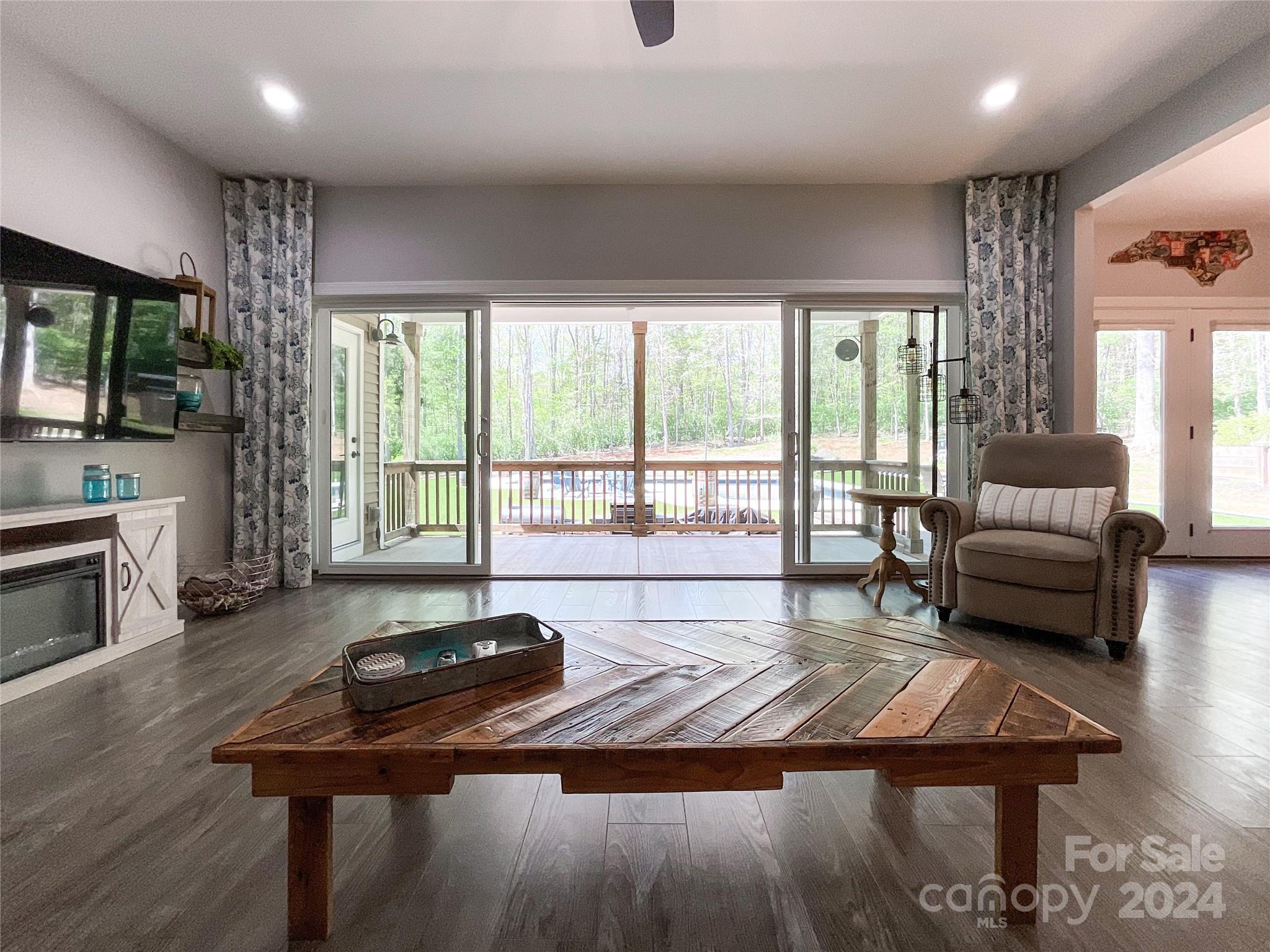 9408 Deer Run Road Waxhaw, NC 28173 - Photo 10 of 47 a living room with furniture a flat screen tv and a large window