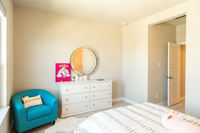 a bedroom with a bed and a dresser