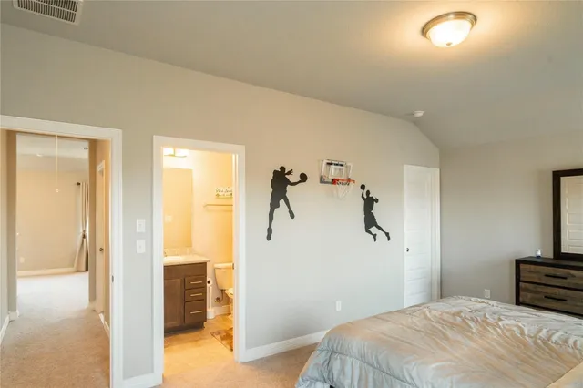 a bedroom with a bed and a view of bathroom