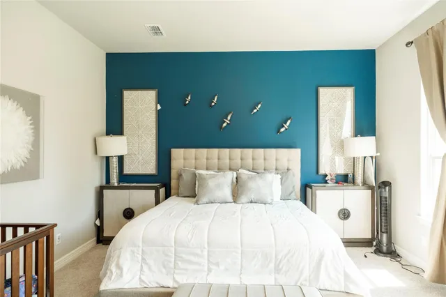 a bedroom with a bed and a lamp on table