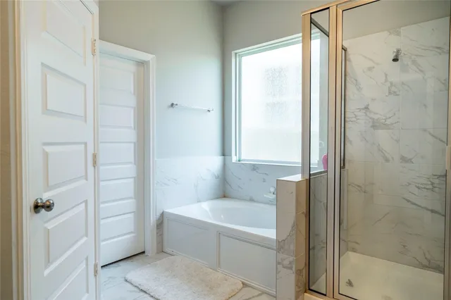 a bathroom with a tub and shower