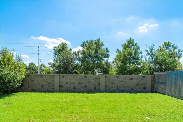 a view of garden with trees in the background
