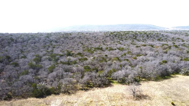 a view of a dry yard covered with snow