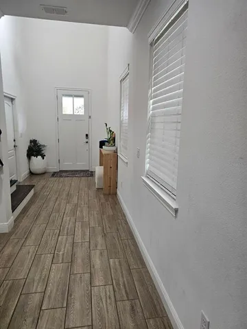 a view of a livingroom with wooden floor and staircase