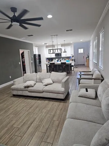 a living room with furniture and kitchen view