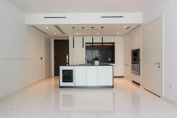 a kitchen with stainless steel appliances a refrigerator and a microwave