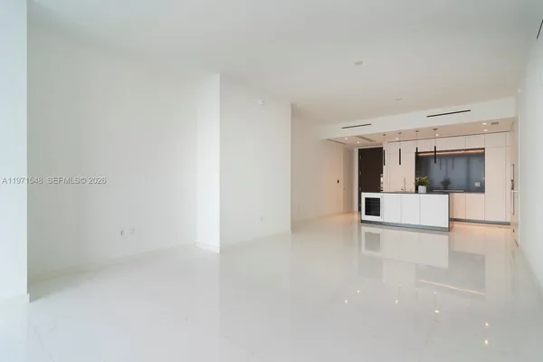a kitchen with refrigerator and microwave