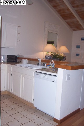 101 Hui Rd F, Unit F KIPA VILLAGE B2 Lahaina, HI 96761 - Photo 5 of 10 a kitchen with granite countertop white cabinets and white appliances