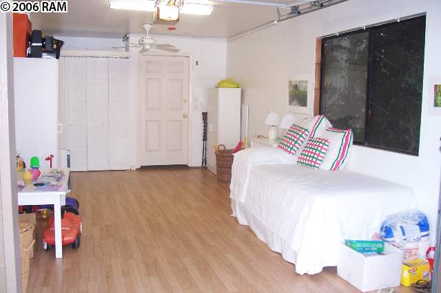 101 Hui Rd F, Unit F KIPA VILLAGE B2 Lahaina, HI 96761 - Photo 7 of 10 a spacious bedroom with a bed dresser and a window