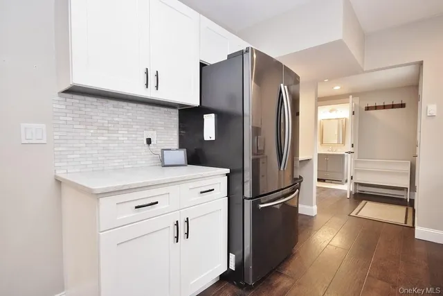 a kitchen with stainless steel appliances a refrigerator and a stove top oven