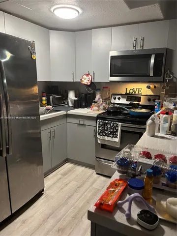 a kitchen with stainless steel appliances a stove and a microwave