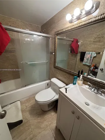 a bathroom with a sink mirror and toilet