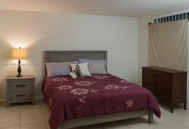 a bedroom with a bed and a night stand