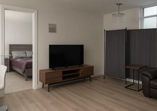 a living room with furniture and a flat screen tv